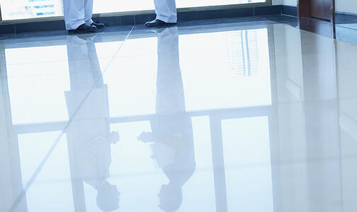 two people reflected in white floor Thumbnail