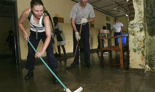 Woman mopping the floor from moisture damage Thumbnail